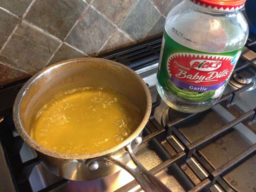 This year, instead of making a homemade vinegar / salt / detergent spray, I thought I would try to boil down leftover pickle juice to make a super-concentrated spray.  Did you know that pickle juice has vinegar and salt, and yes -- even detergents (polysorbate80) in it?  I squirted this into the hole leftover after I picked some dandelions, but I'm not convinced it is strong enough to kill the taproot.  The next day, some of the grass around the dent was yellowed, which tells me it's working on some level -- just maybe not the level I need!
